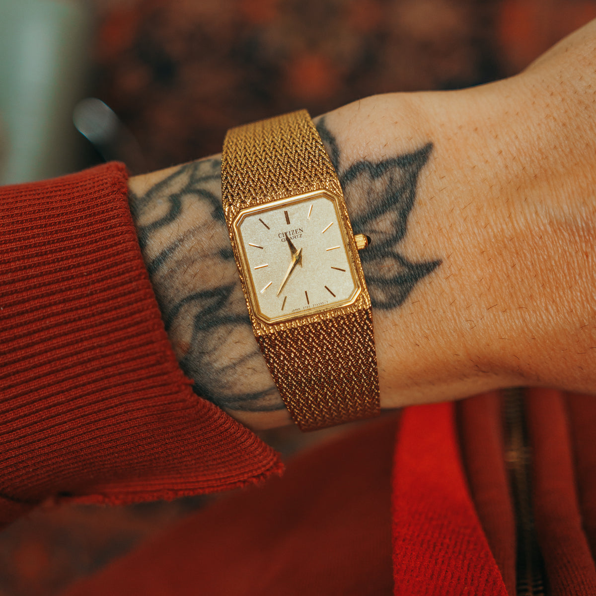 Citizen Woven Sauce gold-tone woven bracelet on wrist