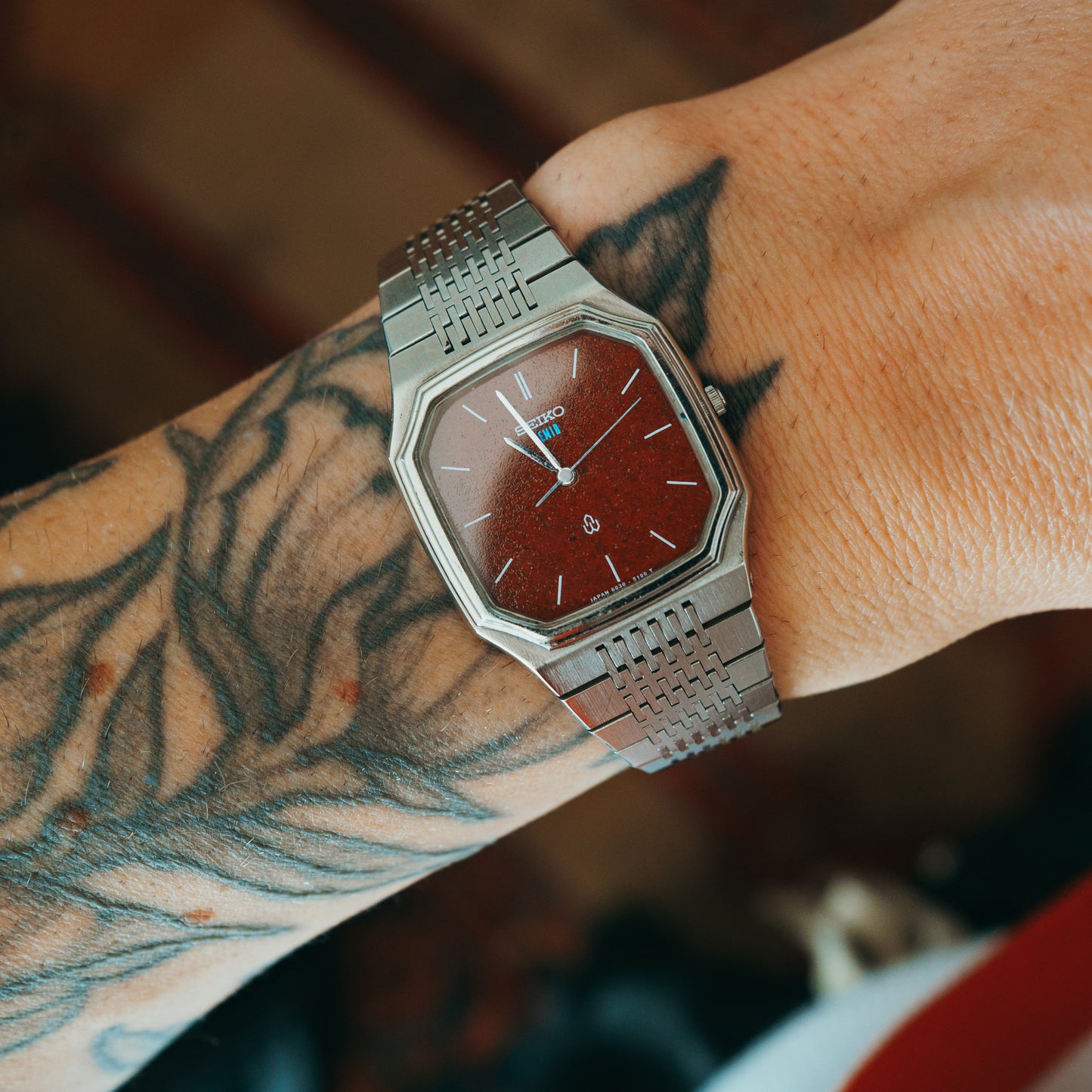 Seiko Quartz red garnet custom dial front view on wrist