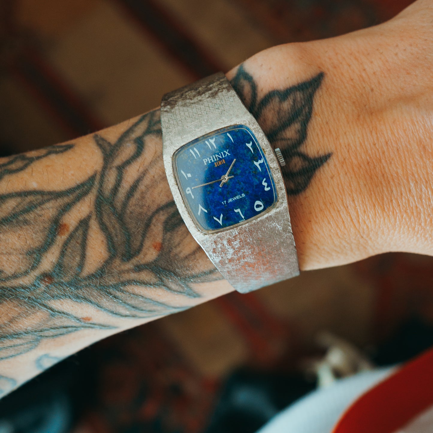 Phinix Swiss lapis dial with Arabic numerals front view on wrist