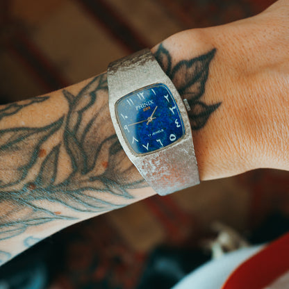 Phinix Swiss lapis dial with Arabic numerals front view on wrist