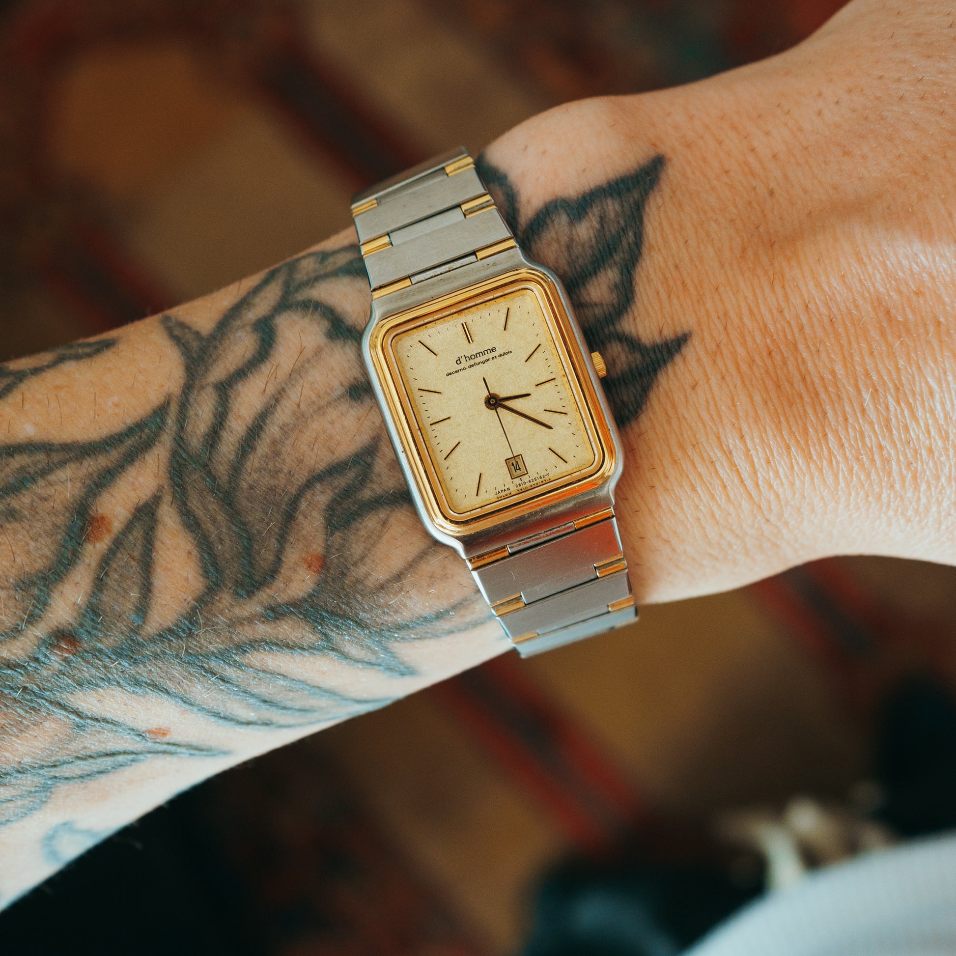 D'Homme Quartz two-tone champagne dial front view on wrist