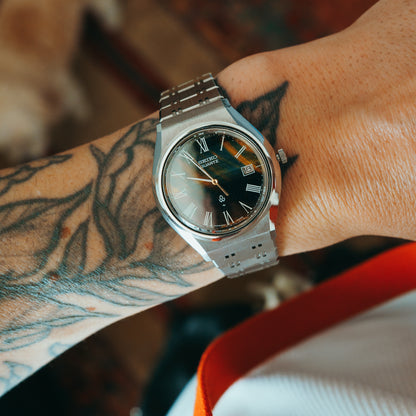 Seiko Quartz tigers eye gradient dial with Roman numerals front view on wrist