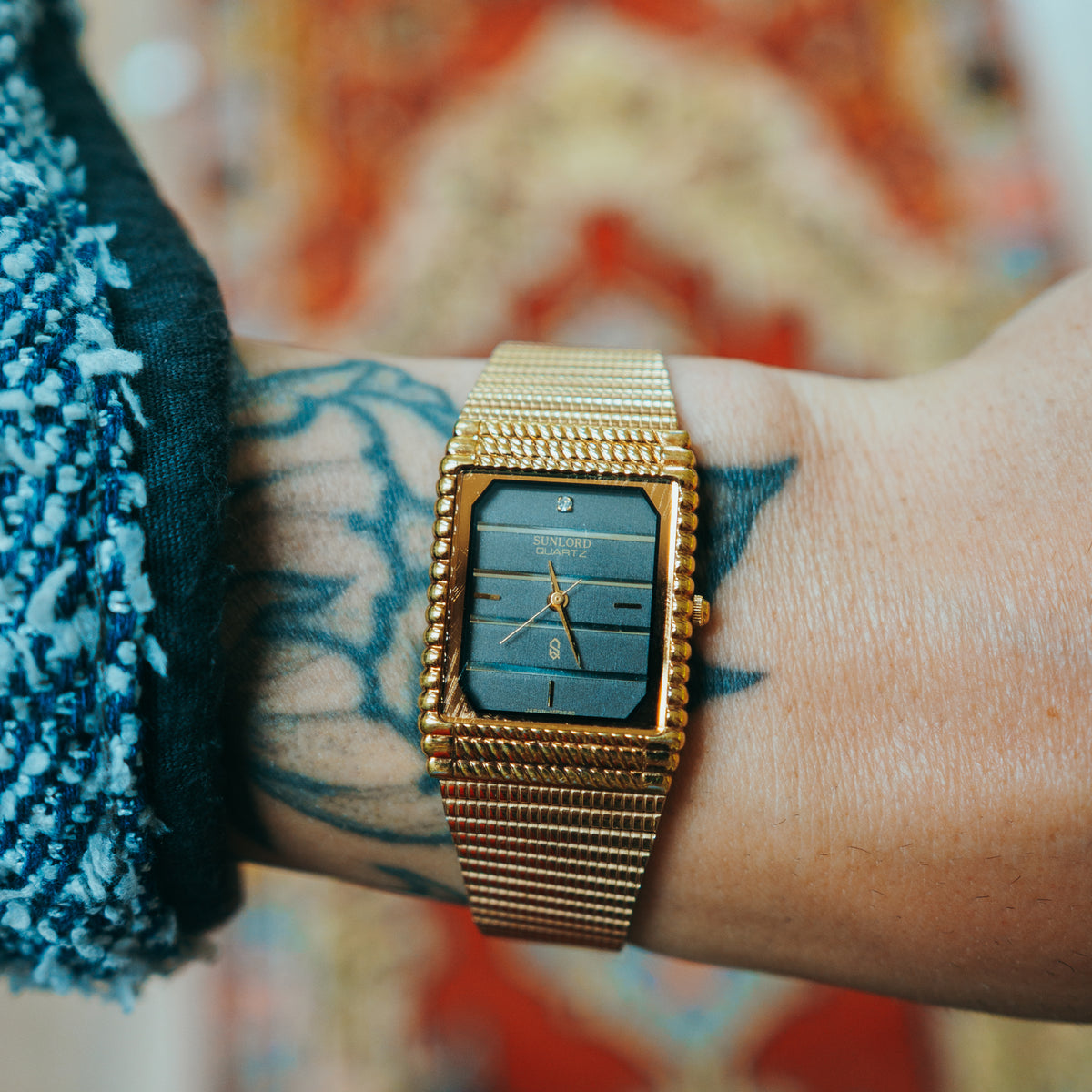 Sunlord Quartz - blue layered dial with rope bezel and gold case on wrist
