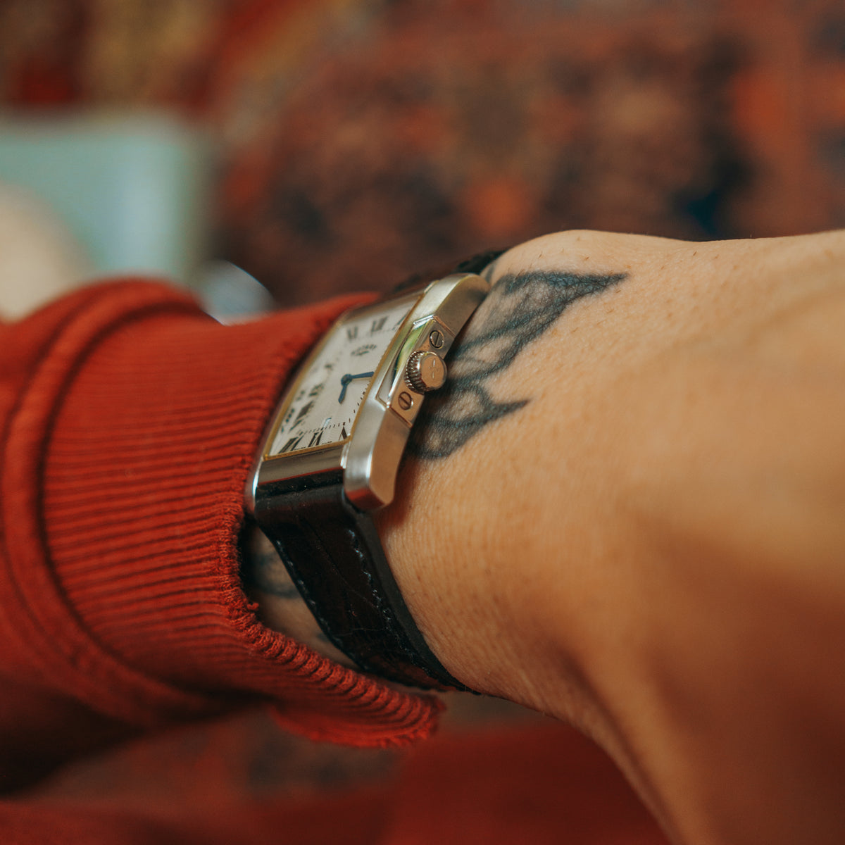Rotary rectangular Roman numeral dial on wrist